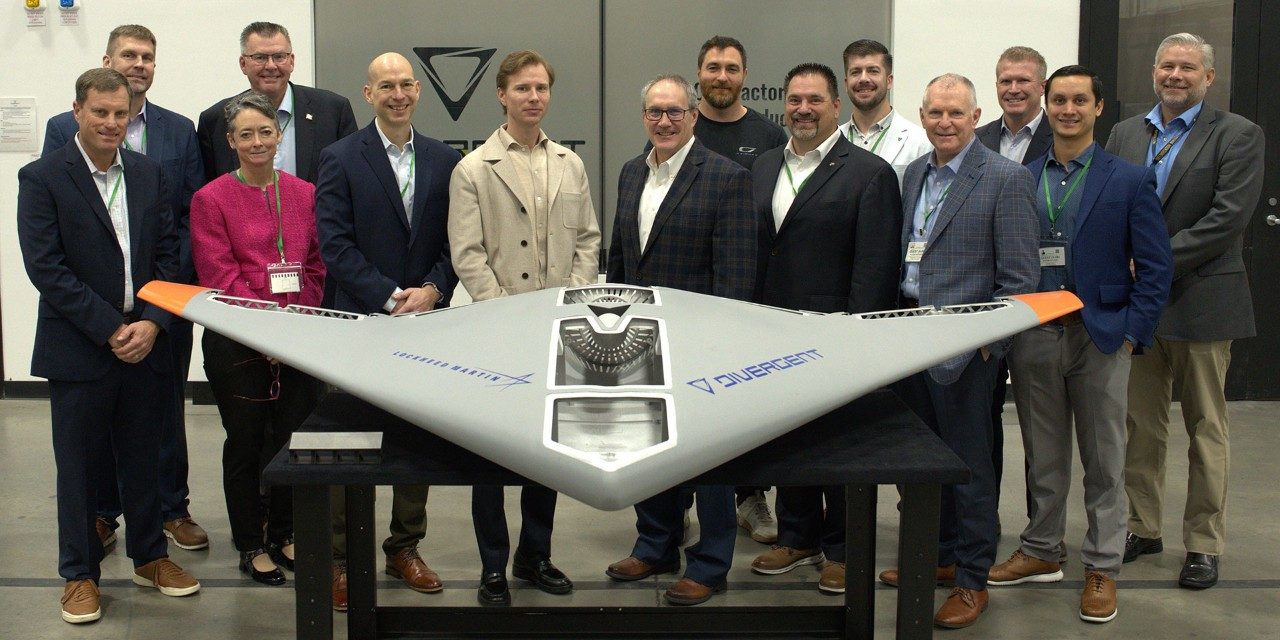 Leaders from Lockheed Martin and Divergent stand behind the Replicator prototype that the companies created together.